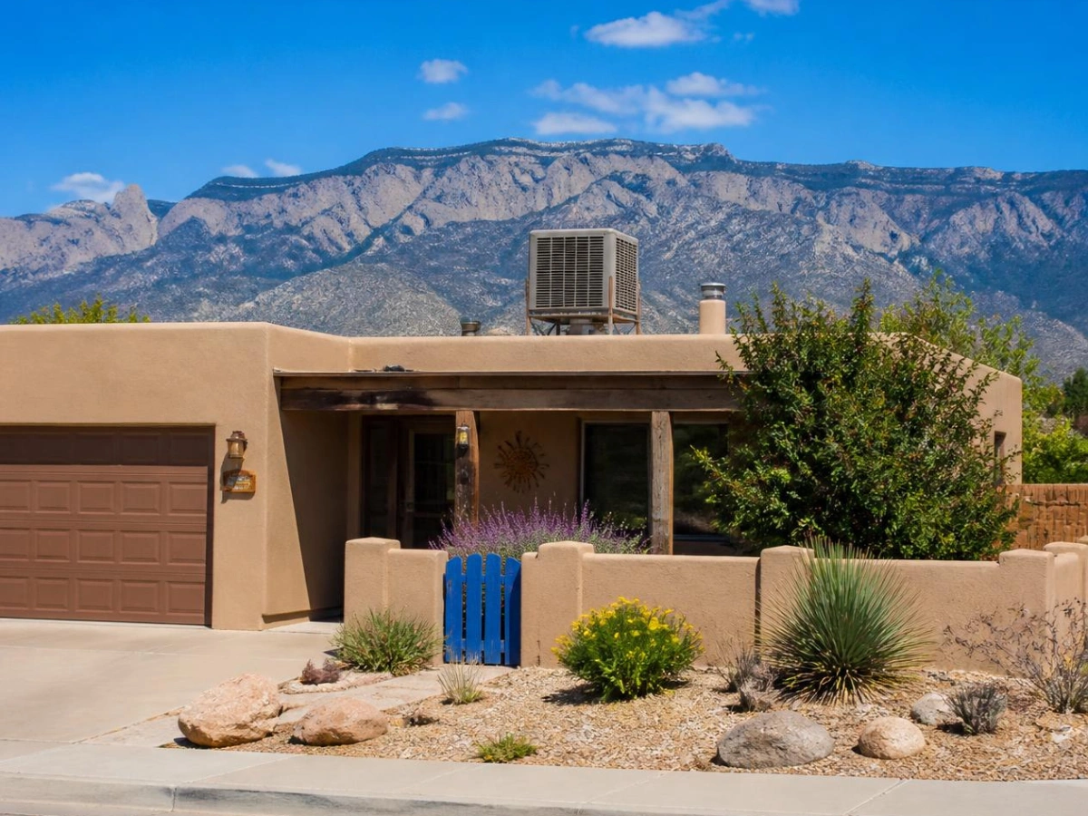 Swamp cooler conversion in Albuquerque with a rooftop evaporative cooler and a new refrigerated air condenser unit on the same home